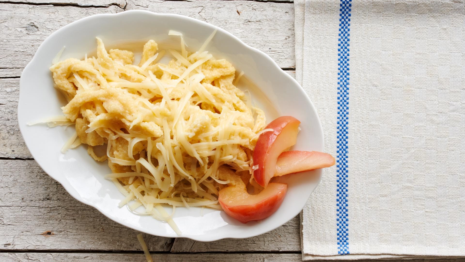 Emmentaler AOP cheese spaetzle (homemade pasta) with apple slices